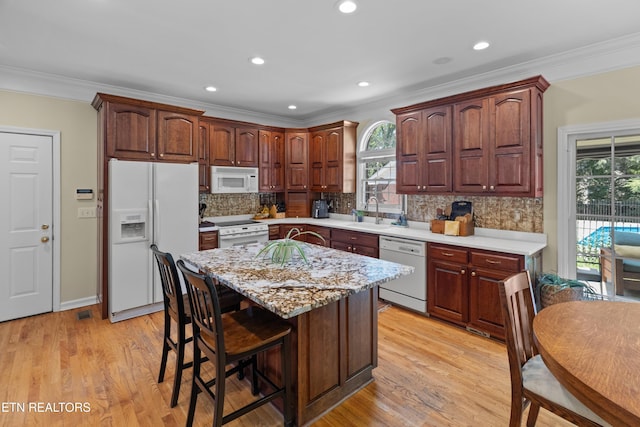 112 Reed Cir, Johnson City, TN 37601 - kitchen featuring white appliances, ornamental molding, plenty of natural light, a kitchen bar, and backsplash