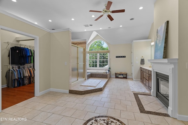112 Reed Cir, Johnson City, TN 37601 - full bathroom featuring vanity, a ceiling fan, a bath, a shower stall, and a fireplace with flush hearth