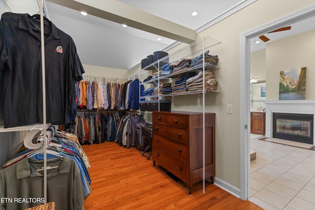 112 Reed Cir, Johnson City, TN 37601 - spacious closet with light wood finished floors, a fireplace with flush hearth, and a ceiling fan
