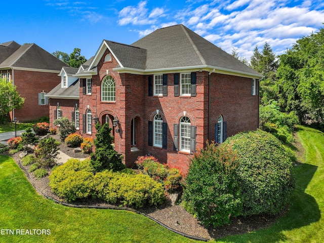 112 Reed Cir, Johnson City, TN 37601 - colonial inspired home with brick siding, a front lawn, and a shingled roof