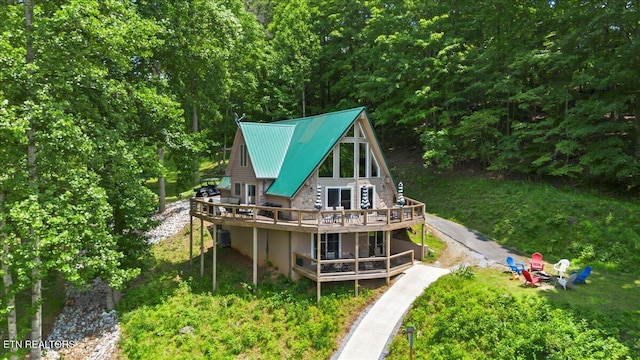 824 Deerfield Way, Lafollette, TN 37766 - rear view of house featuring a wooden deck, an outdoor fire pit, a metal roof, and stone siding