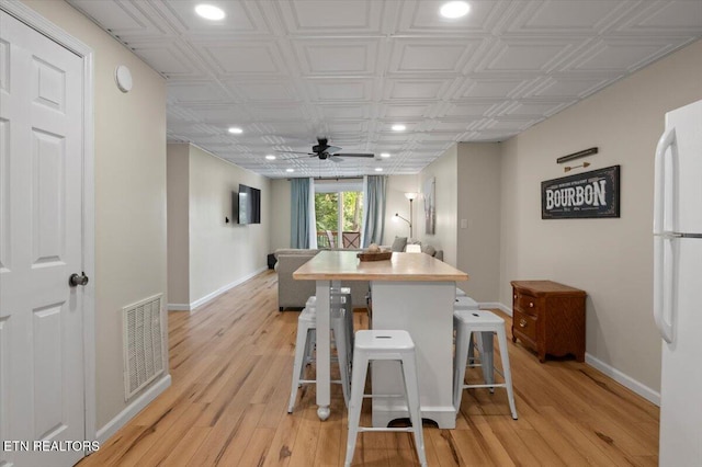 824 Deerfield Way, Lafollette, TN 37766 - kitchen featuring freestanding refrigerator, ceiling fan, light wood finished floors, recessed lighting, and a breakfast bar area