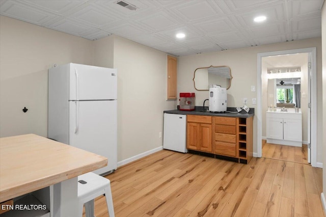 824 Deerfield Way, Lafollette, TN 37766 - kitchen with freestanding refrigerator, recessed lighting, dishwasher, light wood-style floors, and dark countertops