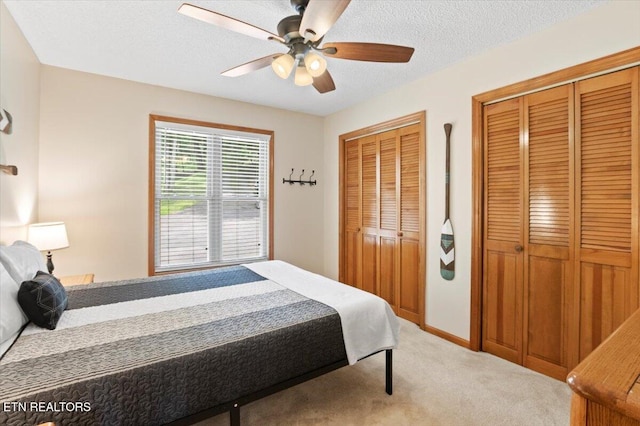 824 Deerfield Way, Lafollette, TN 37766 - bedroom with multiple closets, light carpet, a ceiling fan, and a textured ceiling