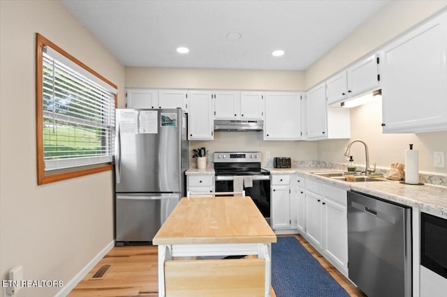 824 Deerfield Way, Lafollette, TN 37766 - kitchen featuring stainless steel appliances, under cabinet range hood, light wood-style flooring, light countertops, and white cabinetry