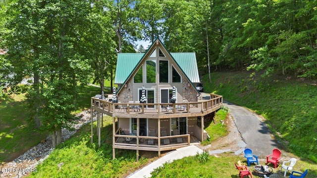 824 Deerfield Way, Lafollette, TN 37766 - back of property with a deck, a fire pit, and a metal roof