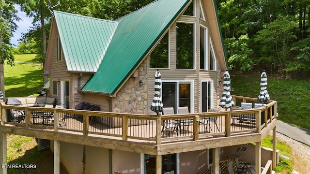 824 Deerfield Way, Lafollette, TN 37766 - back of property with a wooden deck, stone siding, and a metal roof