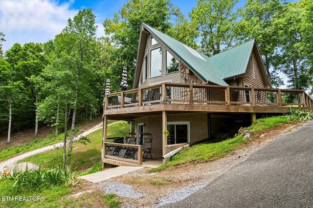 824 Deerfield Way, Lafollette, TN 37766 - rear view of house featuring a wooden deck and a metal roof