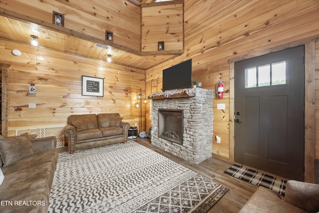 3169 Bear Mountain Ln, Sevierville, TN 37876 - living area with wood walls, a stone fireplace, wood finished floors, and wood ceiling