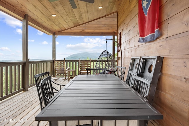 3169 Bear Mountain Ln, Sevierville, TN 37876 - deck with outdoor dining area, a mountain view, and a ceiling fan