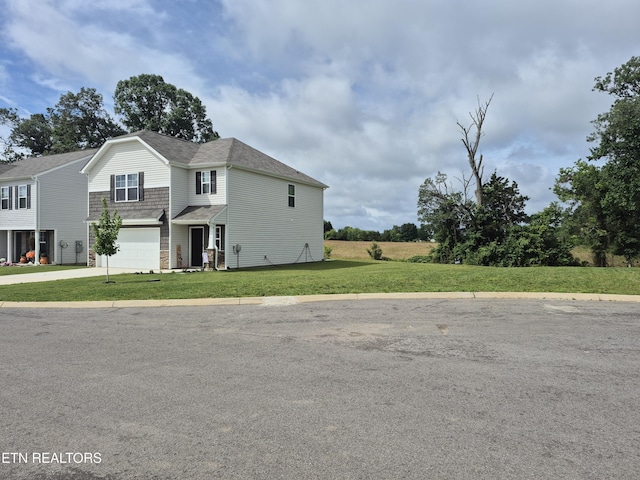 7515 Grasshopper Ln, Corryton, TN 37721 - view of front of house featuring an attached garage, concrete driveway, and a front yard