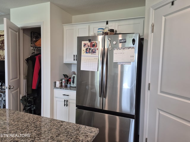 7515 Grasshopper Ln, Corryton, TN 37721 - kitchen featuring freestanding refrigerator, white cabinets, and dark stone counters