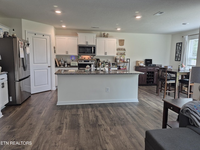 7515 Grasshopper Ln, Corryton, TN 37721 - kitchen with appliances with stainless steel finishes, white cabinetry, dark stone countertops, dark wood-style flooring, and recessed lighting