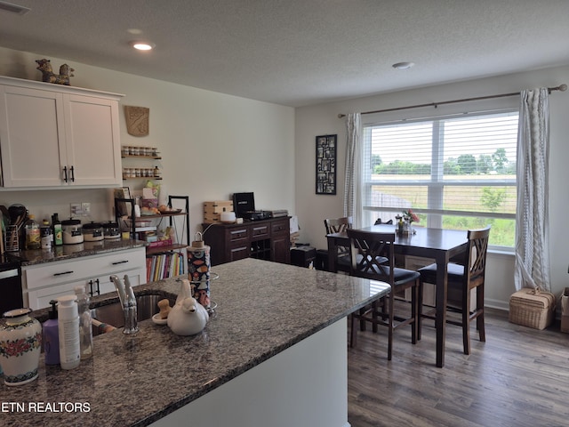 7515 Grasshopper Ln, Corryton, TN 37721 - kitchen featuring wood finished floors, white cabinetry, recessed lighting, a textured ceiling, and dark stone countertops