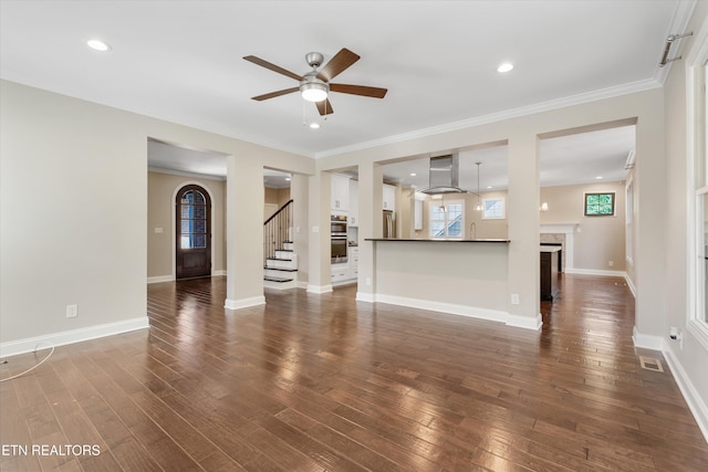 9208 Palomino Way, Knoxville, TN 37922 - unfurnished living room featuring ceiling fan, stairway, dark wood finished floors, ornamental molding, and plenty of natural light