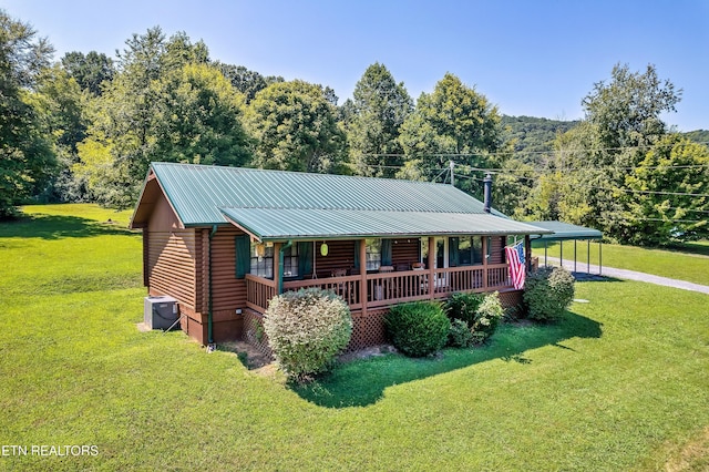 509 Thomas Loop Rd, Sevierville, TN 37876 - log cabin with covered porch, a front lawn, a carport, and a metal roof