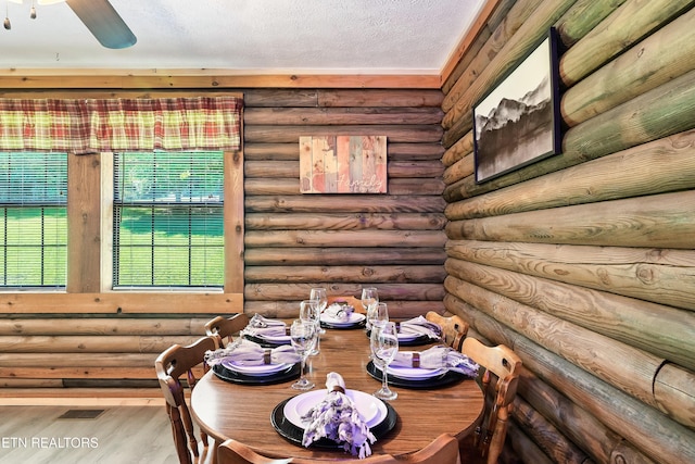 509 Thomas Loop Rd, Sevierville, TN 37876 - dining room with wood finished floors, log walls, a textured ceiling, and ceiling fan