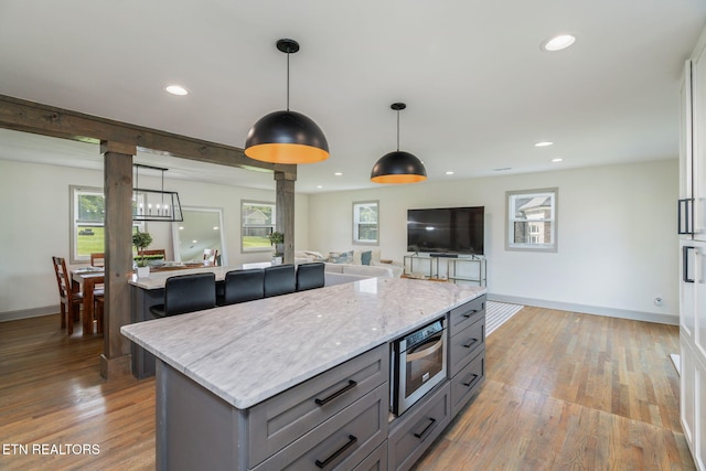 713 Concord Rd, Knoxville, TN 37934 - kitchen with ornate columns, gray cabinets, decorative light fixtures, light wood-style flooring, and recessed lighting
