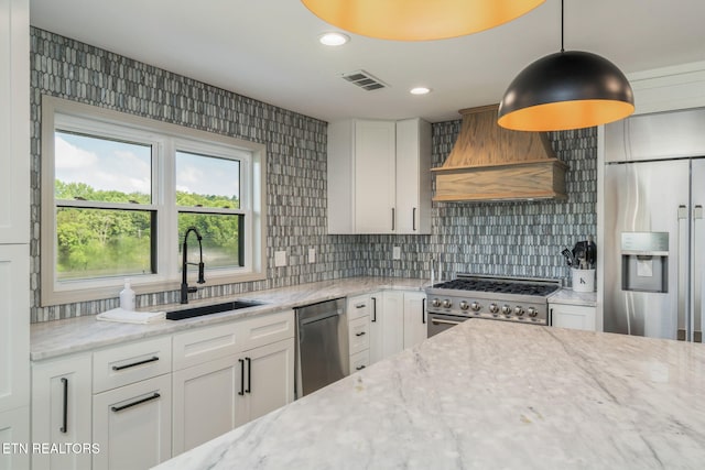 713 Concord Rd, Knoxville, TN 37934 - kitchen featuring stainless steel appliances, custom range hood, light stone counters, tasteful backsplash, and white cabinets