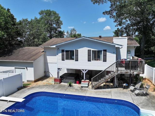 616 Loop Rd, Knoxville, TN 37934 - back of property featuring a jacuzzi, a patio area, stairs, a shingled roof, and an outdoor pool