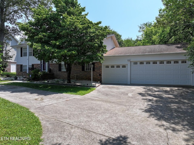 616 Loop Rd, Knoxville, TN 37934 - view of front facade with asphalt driveway, a garage, and brick siding