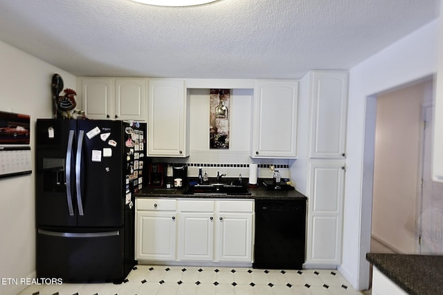 616 Loop Rd, Knoxville, TN 37934 - kitchen featuring black appliances, dark countertops, white cabinetry, light flooring, and a textured ceiling