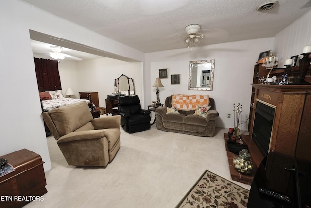 616 Loop Rd, Knoxville, TN 37934 - living area featuring ceiling fan, carpet floors, a fireplace, and a textured ceiling