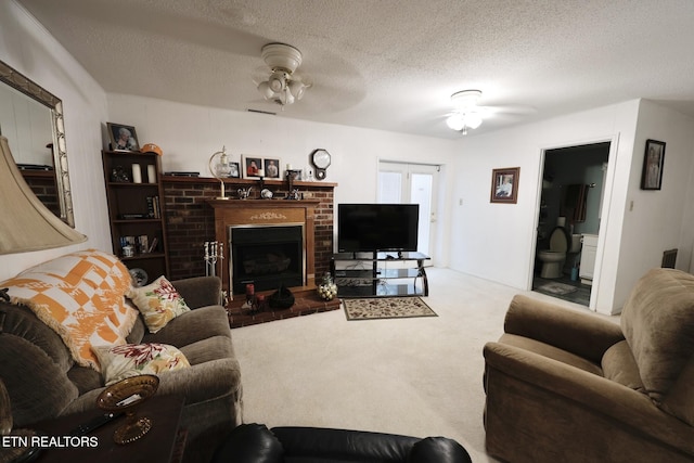 616 Loop Rd, Knoxville, TN 37934 - carpeted living area with ceiling fan, a fireplace, and a textured ceiling