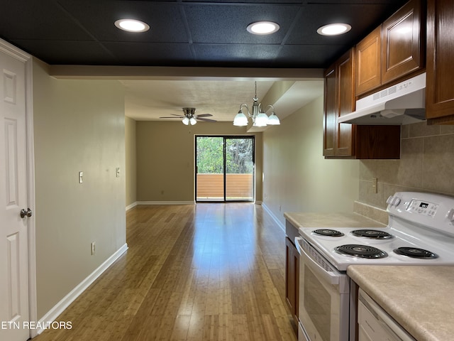 112 Olympia Dr, Alcoa, TN 37701 - kitchen with white appliances, under cabinet range hood, backsplash, light countertops, and light wood-style flooring
