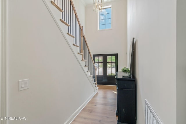 1100 Regality Way, Knoxville, TN 37923 - entrance foyer featuring a chandelier, stairway, light wood-style flooring, crown molding, and a towering ceiling