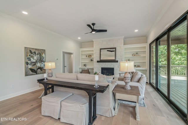 1100 Regality Way, Knoxville, TN 37923 - living area with ceiling fan, crown molding, a stone fireplace, light wood finished floors, and built in shelves