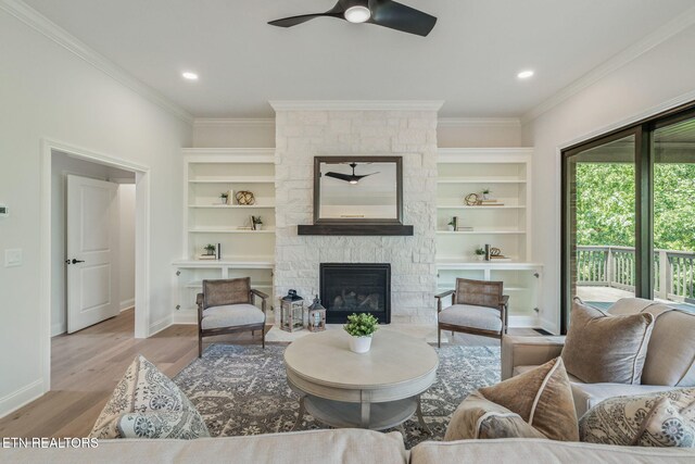 1100 Regality Way, Knoxville, TN 37923 - living room with ornamental molding, a stone fireplace, ceiling fan, wood finished floors, and built in shelves