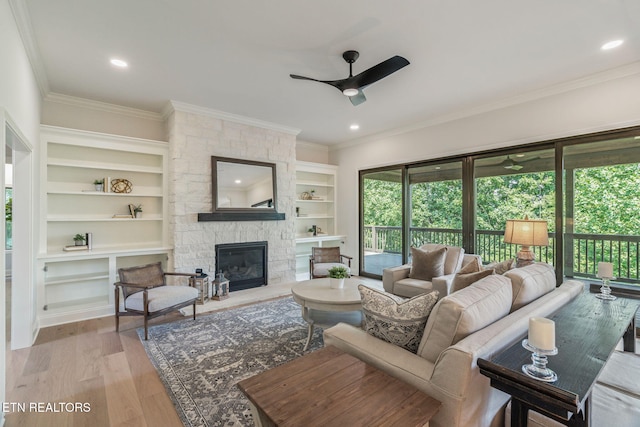 1100 Regality Way, Knoxville, TN 37923 - living area featuring a ceiling fan, built in shelves, crown molding, a fireplace, and wood finished floors