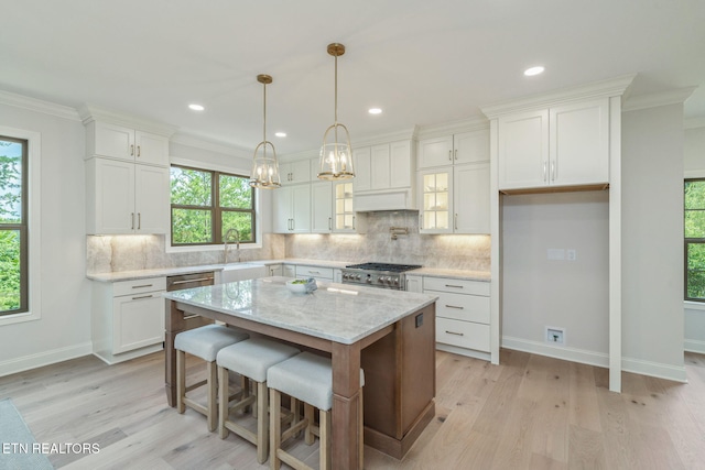 1100 Regality Way, Knoxville, TN 37923 - kitchen featuring light wood-type flooring, healthy amount of natural light, white cabinets, ornamental molding, and recessed lighting