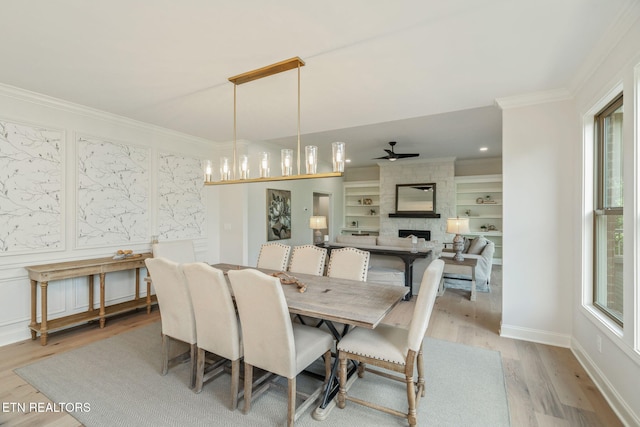 1100 Regality Way, Knoxville, TN 37923 - dining area with light wood-type flooring, a fireplace, crown molding, plenty of natural light, and built in shelves
