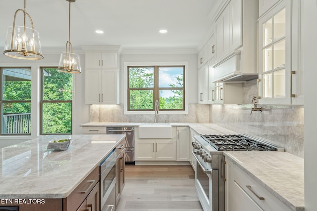 1100 Regality Way, Knoxville, TN 37923 - kitchen featuring appliances with stainless steel finishes, white cabinetry, light wood finished floors, light stone countertops, and a chandelier