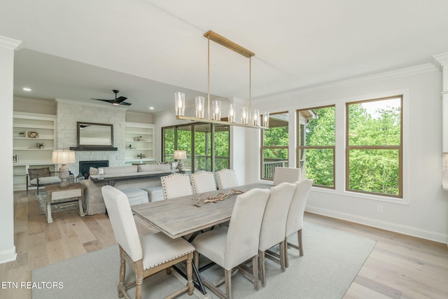 1100 Regality Way, Knoxville, TN 37923 - dining space with crown molding, plenty of natural light, light wood-style flooring, a fireplace, and ceiling fan