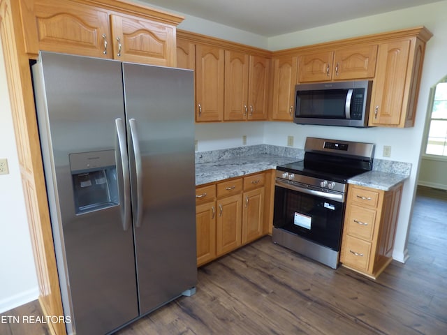 363 Smith Rd, Crossville, TN 38571 - kitchen featuring appliances with stainless steel finishes, dark wood finished floors, and light stone counters