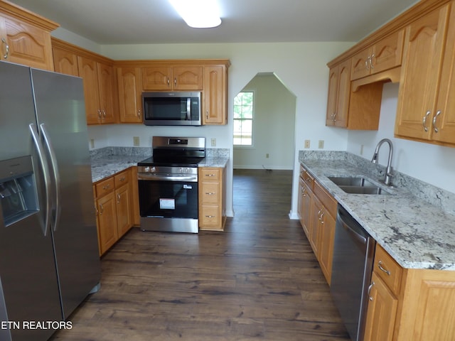 363 Smith Rd, Crossville, TN 38571 - kitchen featuring appliances with stainless steel finishes, dark wood-style flooring, light stone counters, and arched walkways