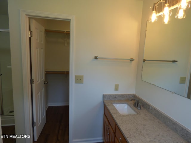 363 Smith Rd, Crossville, TN 38571 - bathroom featuring vanity, a walk in closet, a chandelier, and an enclosed shower