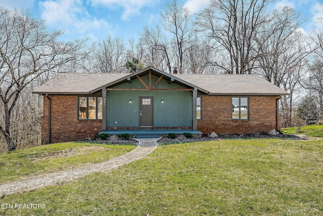 307 Gillen Dr, Sparta, TN 38583 - view of front facade with brick siding, a front lawn, and roof with shingles