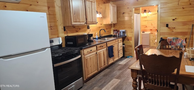 1955 Terry Rd, Oneida, TN 37841 - kitchen featuring freestanding refrigerator, stainless steel gas stove, black microwave, dark countertops, and wood walls