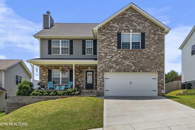 1152 Cloud View Dr, Powell, TN 37849 - traditional-style house featuring a porch, board and batten siding, an attached garage, a chimney, and driveway