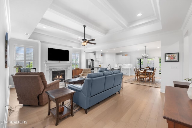 12845 Scarlet Sage Dr, Farragut, TN 37934 - living area featuring a glass covered fireplace, light wood-style floors, ceiling fan, ornamental molding, and beamed ceiling