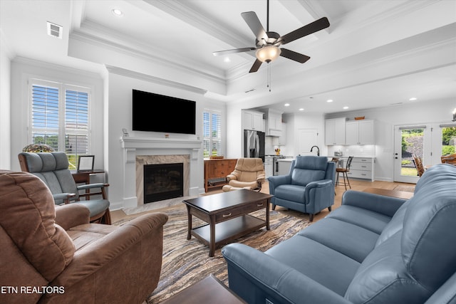 12845 Scarlet Sage Dr, Farragut, TN 37934 - living room featuring a high end fireplace, light wood finished floors, a ceiling fan, recessed lighting, and crown molding