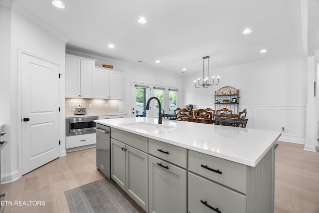 12845 Scarlet Sage Dr, Farragut, TN 37934 - kitchen featuring stainless steel appliances, light wood-type flooring, gray cabinetry, a center island with sink, and hanging light fixtures