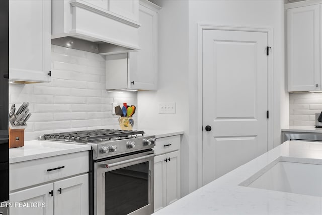 12845 Scarlet Sage Dr, Farragut, TN 37934 - kitchen with high end stainless steel range oven, custom exhaust hood, decorative backsplash, white cabinetry, and light stone counters