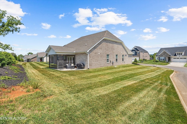 12845 Scarlet Sage Dr, Farragut, TN 37934 - rear view of house featuring a sunroom, brick siding, a lawn, and a residential view