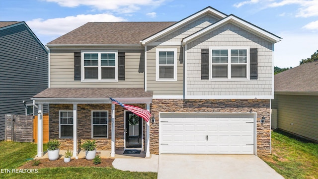 1171 Hampton Place Cir, Loudon, TN 37774 - view of front facade with stone siding, an attached garage, driveway, and a shingled roof