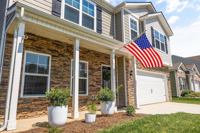 1171 Hampton Place Cir, Loudon, TN 37774 - view of front facade featuring stone siding, driveway, and a porch